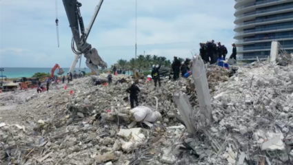 Search-and-rescue crew personnel on the debris of the collapsed Champlain Towers South condominium in Surfside, Florida