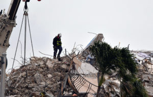 A crew of search and rescue workers on top of what was once Champlain Towers South condominium in Surfside, Florida on Jan. 6, 2021. Photo by Malcolm Denemark-USA TODAY NETWORK