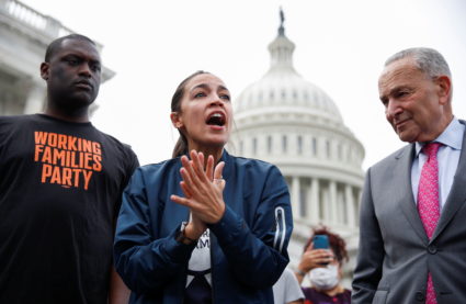 Rep. Alexandria Ocasio-Cortez speaks on Capitol Hill with Rep. Mondaire Jones and Senate Majority Leader Chuck Schumer in ...