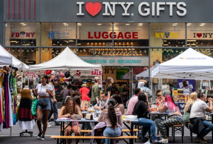 FILE PHOTO: People shop at a street fair near Times Square in New York City