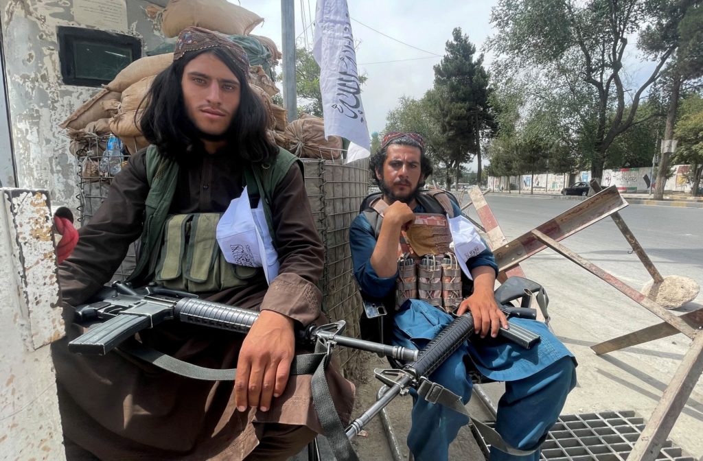 FILE PHOTO: Members of Taliban forces sit at a checkpost in Kabul