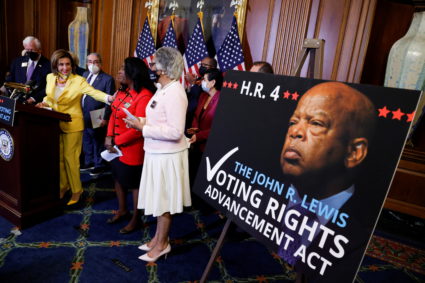 U.S. House Speaker Pelosi celebrates with Representative Sewell after House passage of the John Lewis voting rights act at...