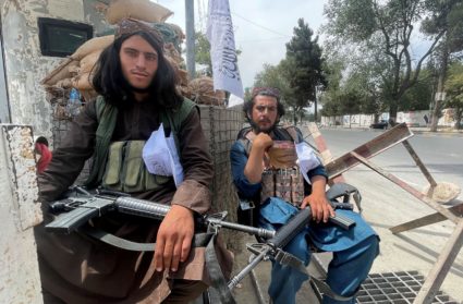 Members of Taliban forces sit at a checkpost in Kabul