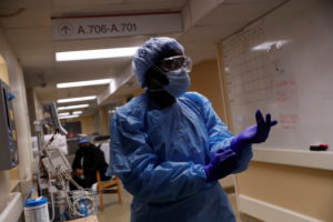 Registered nurse LaToya Marks prepares to treat a coronavirus disease (COVID-19) positive patient in Little Rock, Arkansas