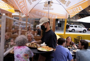 FILE PHOTO: People eat at a restaurant in Manhattan, New York