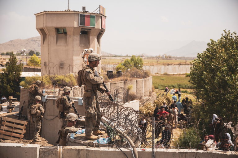 U.S. Marines stand guard at an Evacuee Control Checkpoint at Hamid Karzai International Airport, Kabul