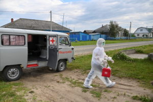 Paramedic Yulia Medvedeva wearing protective suit visits a COVID-19 patient in the village of Martyushevo, Omsk region