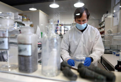 Owner of Luke's Family Pharmacy, pharmacist Luke Snell, makes hand sanitizer with a recently delivered batch of alcohol