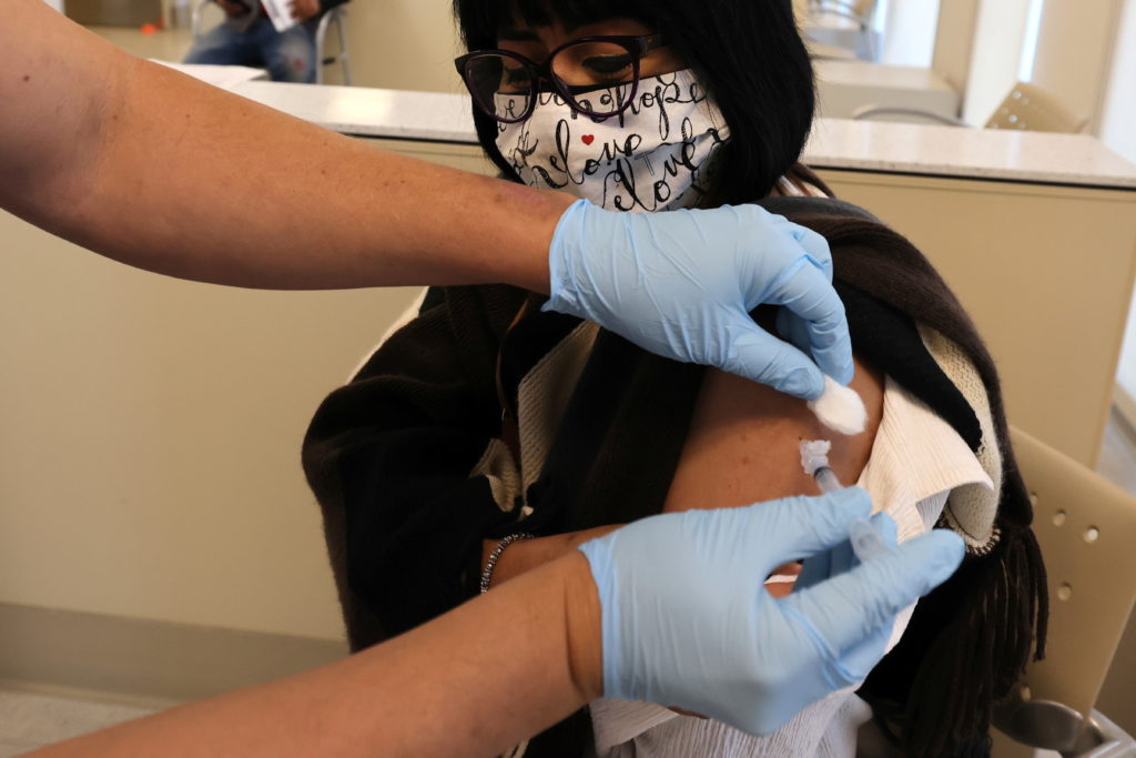 Beltran is given a flu shot in East Los Angeles during the global outbreak of the coronavirus disease (COVID-19)