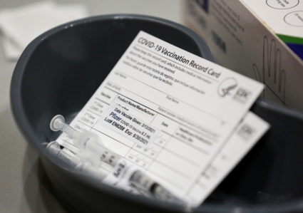 A Pfizer coronavirus disease (COVID-19) vaccine card is seen at a mass vaccination site at Lumen Field Event Center in Sea...