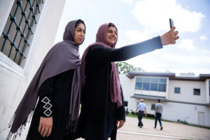 Two Muslim women take pictures after the first Friday prayers during the month of Ramadan at Diyanet Center of America in ...