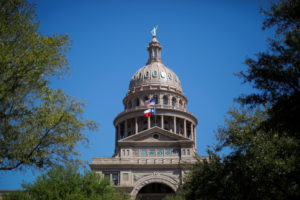 The U.S flag and the Texas State flag fly over the Texas State Capitol as the state senate debates the #SB6 bathroom bill in Austin, Texas, U.S., March 14, 2017. Photo by Brian Snyder/REUTERS