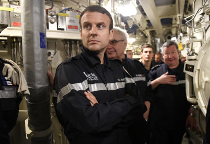 French President Macron looks on as he stands with crew of the submarine "Le Terrible" and Chief of the Special General St...