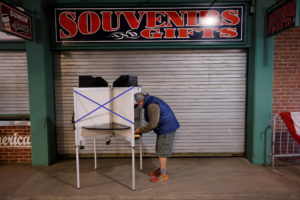 A voter fills out his ballot at Fenway Park on the first day of early voting in Boston