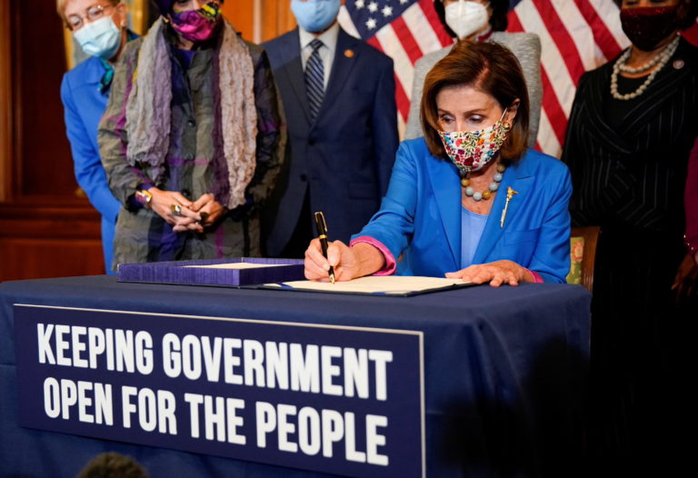 U.S. House Speaker Nancy Pelosi signs continuing resolution during bill enrollment ceremony on Capitol Hill in Washington