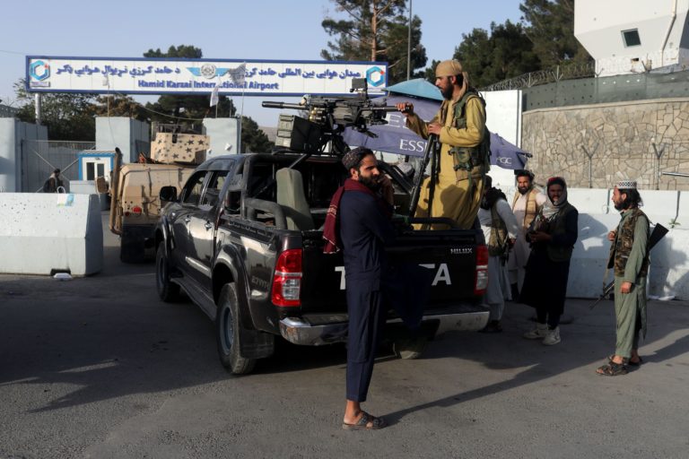 Members of the Taliban guard the entrance to Hamid Karzai International Airport in Kabul