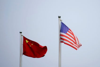 Chinese and U.S. flags flutter outside a company building in Shanghai, China April 14, 2021. Photo by Aly Song/REUTERS