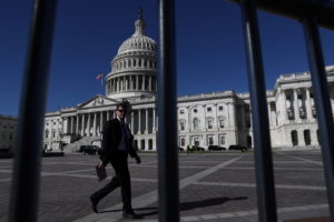 A man walks past the U.S. Capitol building as a government shutdown looms in Washington