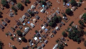 A satellite image shows houses along Boesel Avenue submerged in flood water in Manville, New Jersey, U.S., following torre...