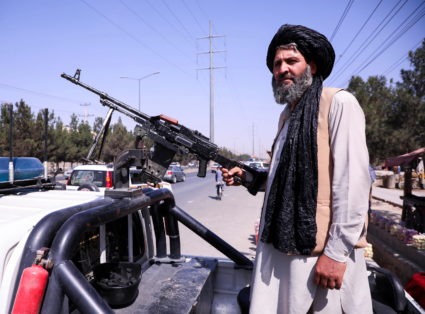 A member of the Taliban force stands guard at a checkpoint in Kabul