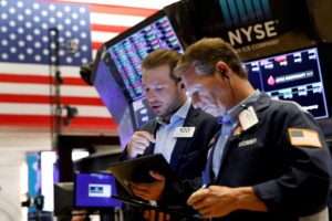 FILE PHOTO: Traders work on the floor of the NYSE in New York