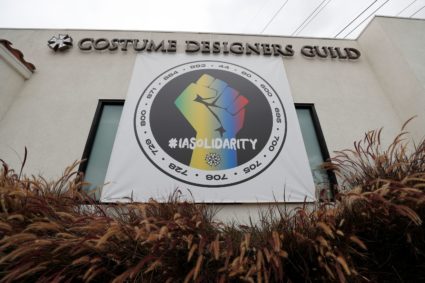 A banner hung in support of the the International Alliance of Theatrical Stage Employees (IATSE) is pictured outside the C...