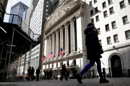 People are seen on Wall Street outside the New York Stock Exchange (NYSE) in New York City, U.S., March 19, 2021. Photo by Brendan McDermid/REUTERS