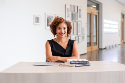 Nicole Fleetwood posing with copies of her book, “Marking Time: Art in the Age of Mass Incarceration.” Photo provided by John D. and Catherine T. MacArthur Foundation