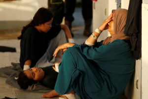 Injured migrants wait to be evacuated by the Italian Coast Guard from the German NGO migrant rescue ship Sea-Watch 3