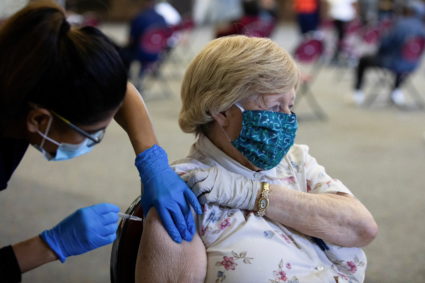 FILE PHOTO: People receive COVID-19 booster vaccination in Michigan