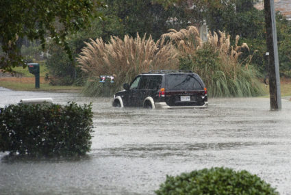A car sits in water after a road was flooded by rain from Hurricane Sandy in Virginia Beach, Virginia