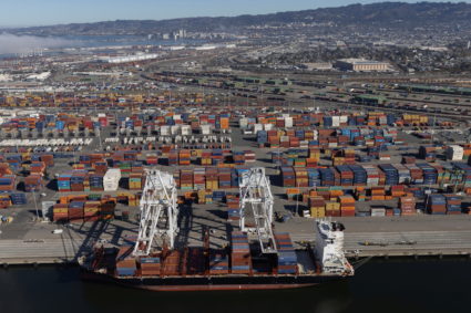 Shipping containers are unloaded from ships at a container terminal at the port of Oakland
