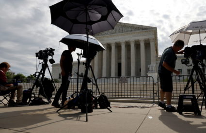 FILE PHOTO: Television news photographers prepare to cover the final opinions of the current court’s term at the U.S. Supr...