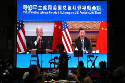 Screen shows Chinese President Xi Jinping attending a virtual meeting with U.S. President Joe Biden via video link, at a r...