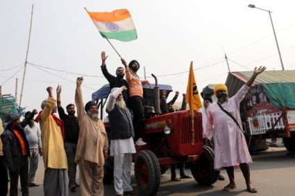 Farmers celebrate after Indian PM Modi announced that he will repeal the controversial farm laws, near Delhi-UP border