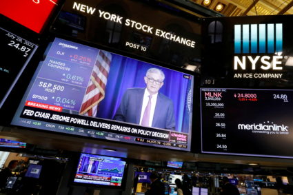 FILE PHOTO: A screen displays the Federal Reserve Chair Powell on the trading floor at New York Stock Exchange (NYSE) in N...