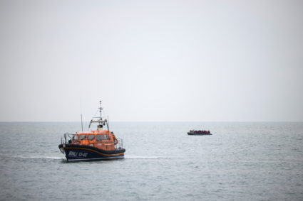 Migrants are escorted ashore by a RNLI Lifeboat, after having crossed the channel, in Dungeness