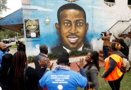 FILE PHOTO: People gather in front of a mural of Ahmaud Arbery in Brunswick