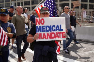 People march to protest against New York City mandated vaccines against the coronavirus disease (COVID-19) in New York