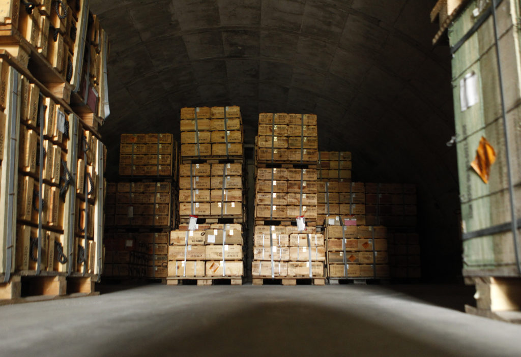 Crated boxes of 57mm caliber rifle cartridges are stacked deep in a munitions bunker at the U.S. Army Letterkenny Munition...