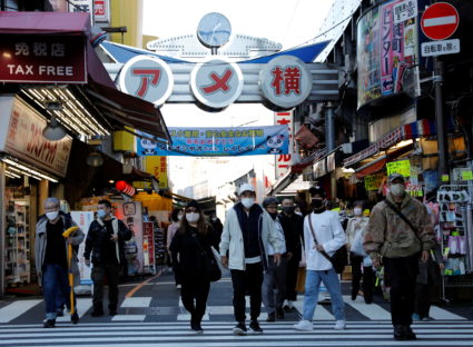 Pedestrians wearing protective masks, amid the coronavirus disease (COVID-19) outbreak, make their way at the Ameyoko shop...