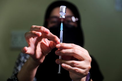 Pharmacist prepares a dose of the coronavirus disease (COVID-19) Pfizer vaccine, in Johannesburg