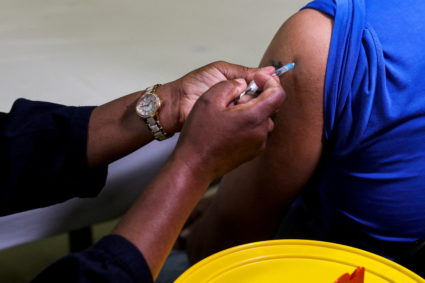 FILE PHOTO: A healthcare worker administers the Pfizer COVID-19) vaccine to a man in Johannesburg