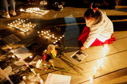 A girl places a flower bouquet to pay tribute to the victims of the Tiananmen Square crackdown in Beijing on June 4, 1989,...