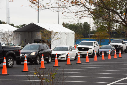 Cars line up at a COVID-19 testing site at the South Orange