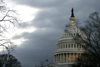 The dome of the United States Capitol building is illuminated at twilight as the [U.S. Congress and ..