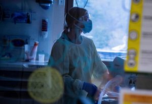 A nurse at the University of Vermont Medical Center Pediatric Intensive Care Unit (ICU) cares for a COVID-19 positive child