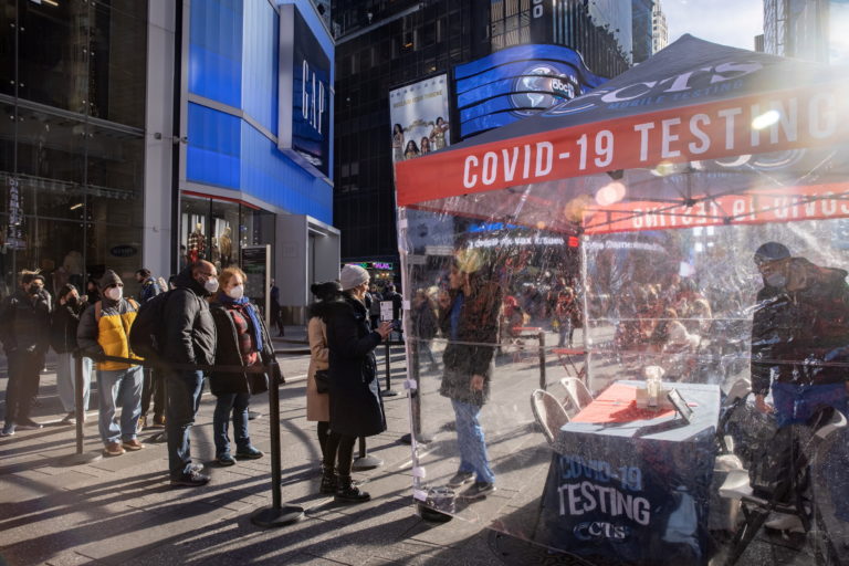People queue at a popup COVID-19 testing site in Times Square in New York City