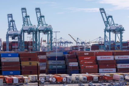 Stacked containers and crains are shown at the Port of Los Angeles in Los Angeles, California