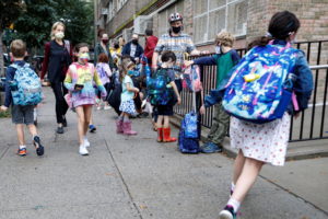 FILE PHOTO: Children arrive at school, amid the coronavirus disease (COVID-19) pandemic in Brooklyn, New York